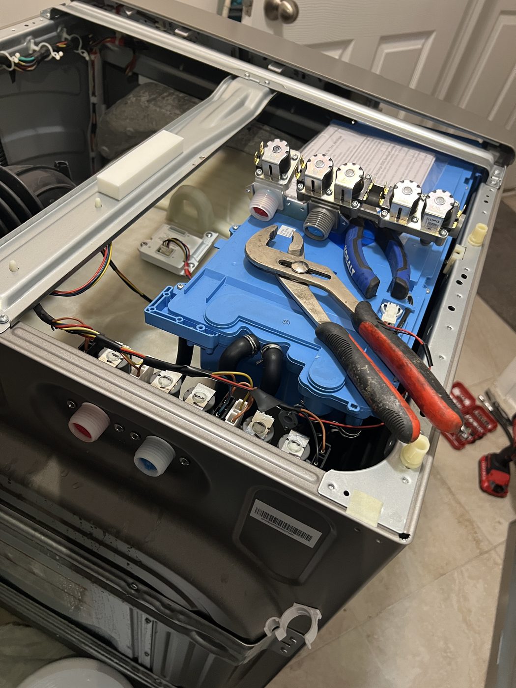 Dishwasher opened up with pliers for inlet valve and wiring work