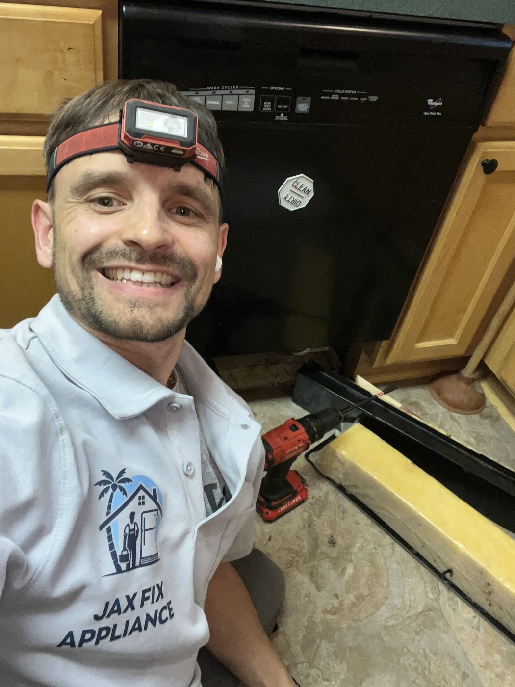 Konstantin in branded Jax Fix Appliance polo at a dishwasher service call